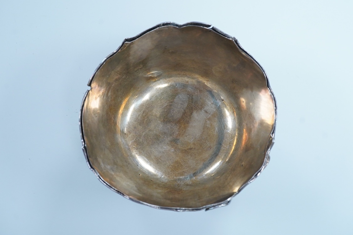 An early 20th century Japanese planished white metal double walled sugar bowl, decorated with the continuous scene of a dragon, signed to the base, diameter 12.1cm, 5.9oz(a.f.).